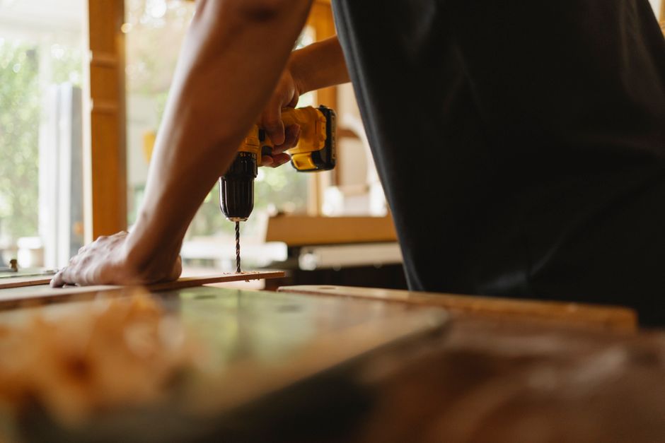 Carpenter carefully installing a new home door